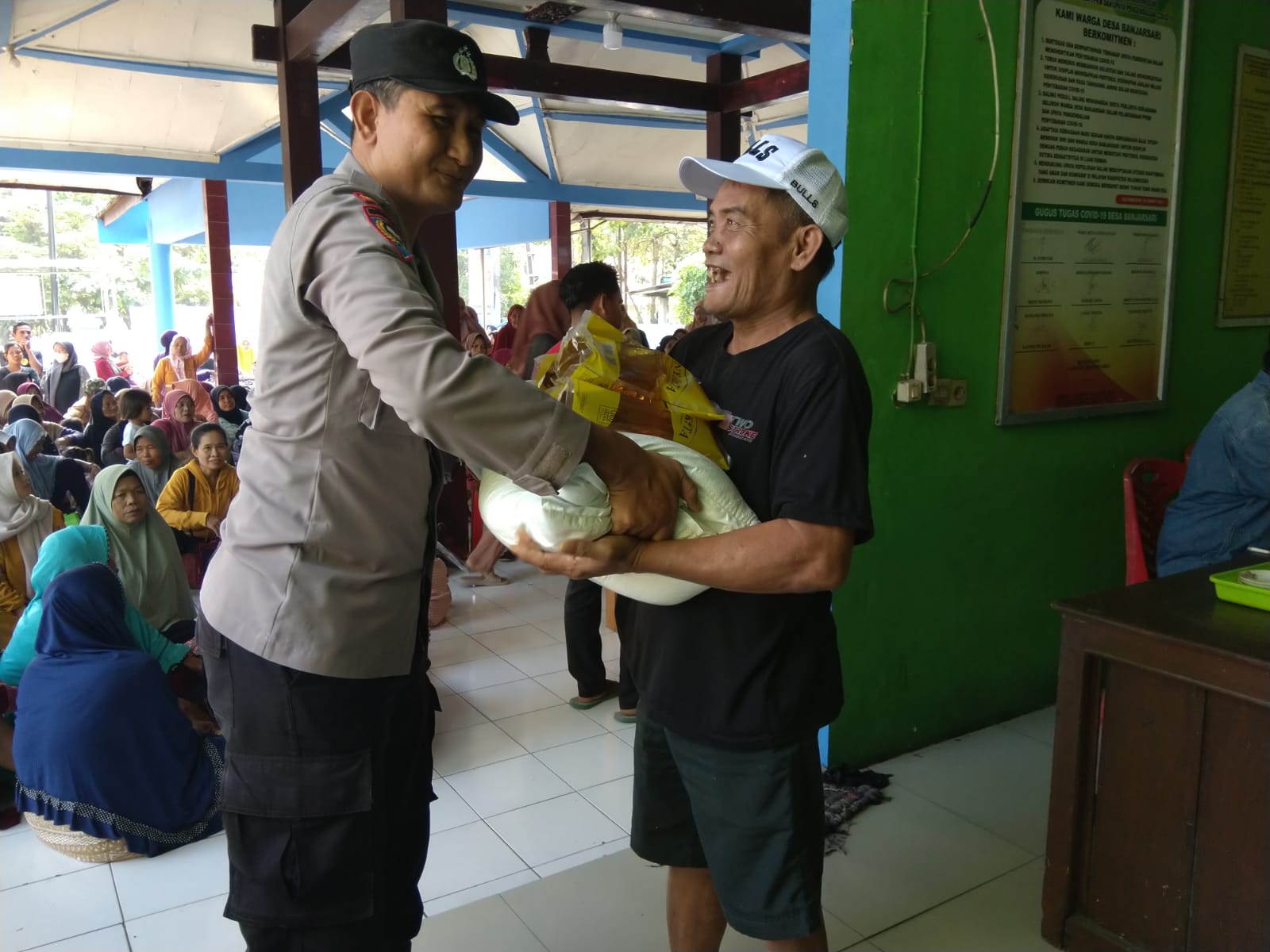 Bhabinkamtibmas Polsek Trucuk Hadir Dan Amankan Penyaluran Bantuan Beras dan Minyak Goreng Bulog di Desa Banjarsari